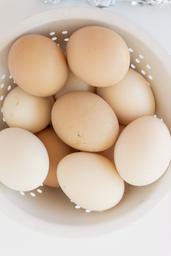 in-shell brown eggs stacked in colander