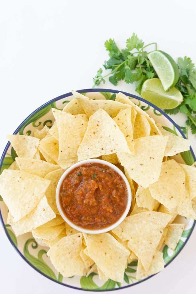 the best salsa recipe in a serving dish on platter with chips for dipping
