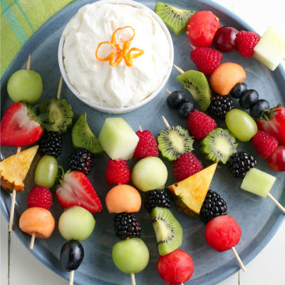 Fruit Kabobs and fruit dip on blue plate for serving