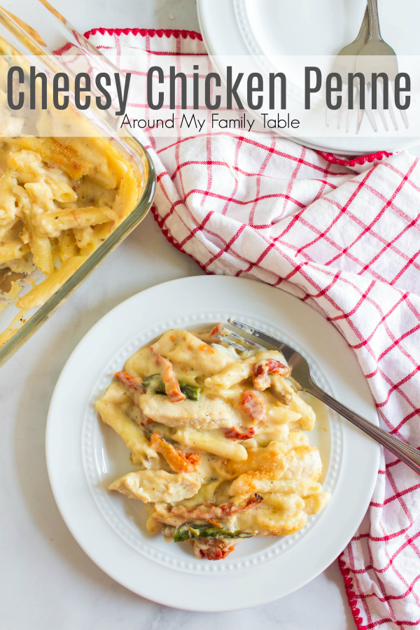 cheesy chicken penne served on a white plate with a red and white napkin