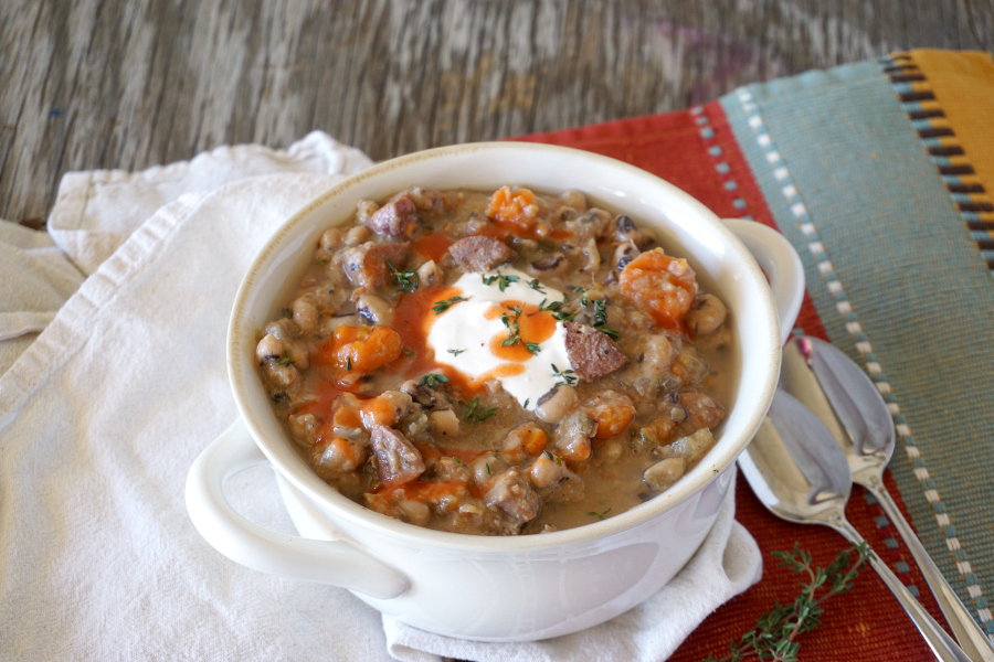 white soup crock filled with slow cooker black eyed pea soup