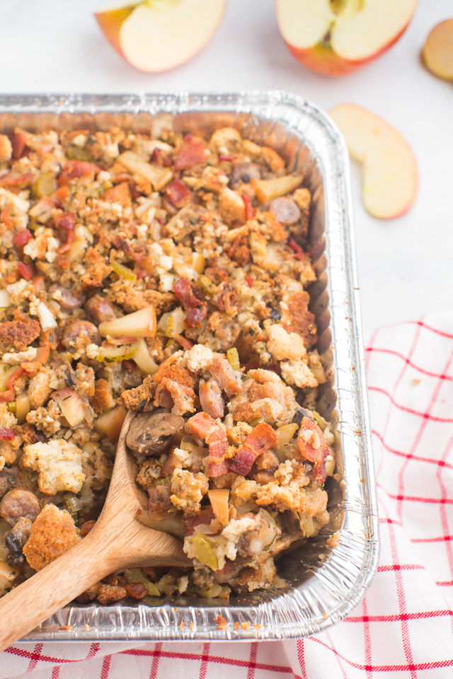 overhead photo: sausage dressing and wooden spoon in disposable aluminium pan