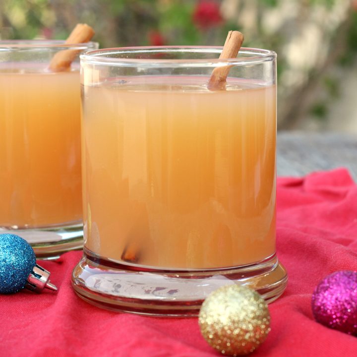 2 glasses filled with slow cooker Christmas wassail