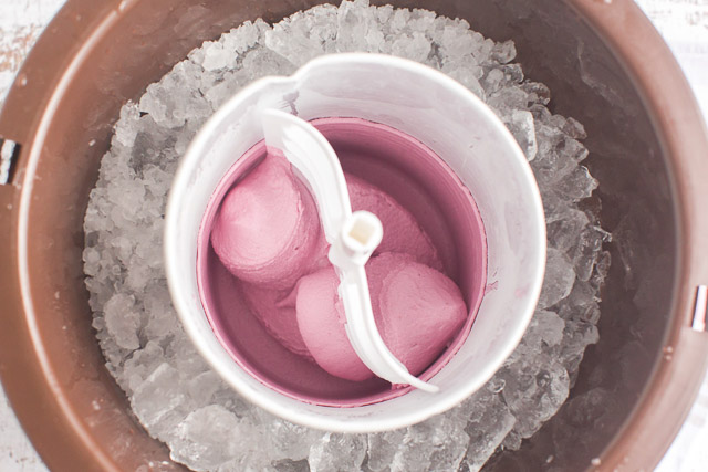 churning fresh fruit ice cream in an ice cream maker