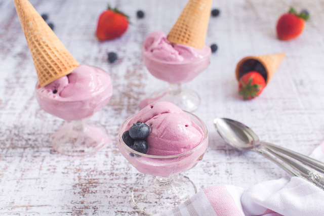 bowls of fresh fruit ice cream topped with sugar cones