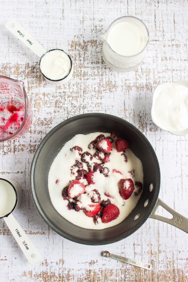 adding half and half to mixed berry puree to make fruit ice cream