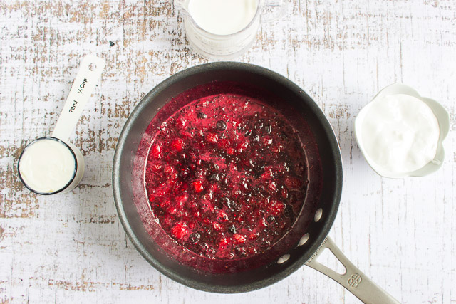 making fresh berry puree in a saucepan