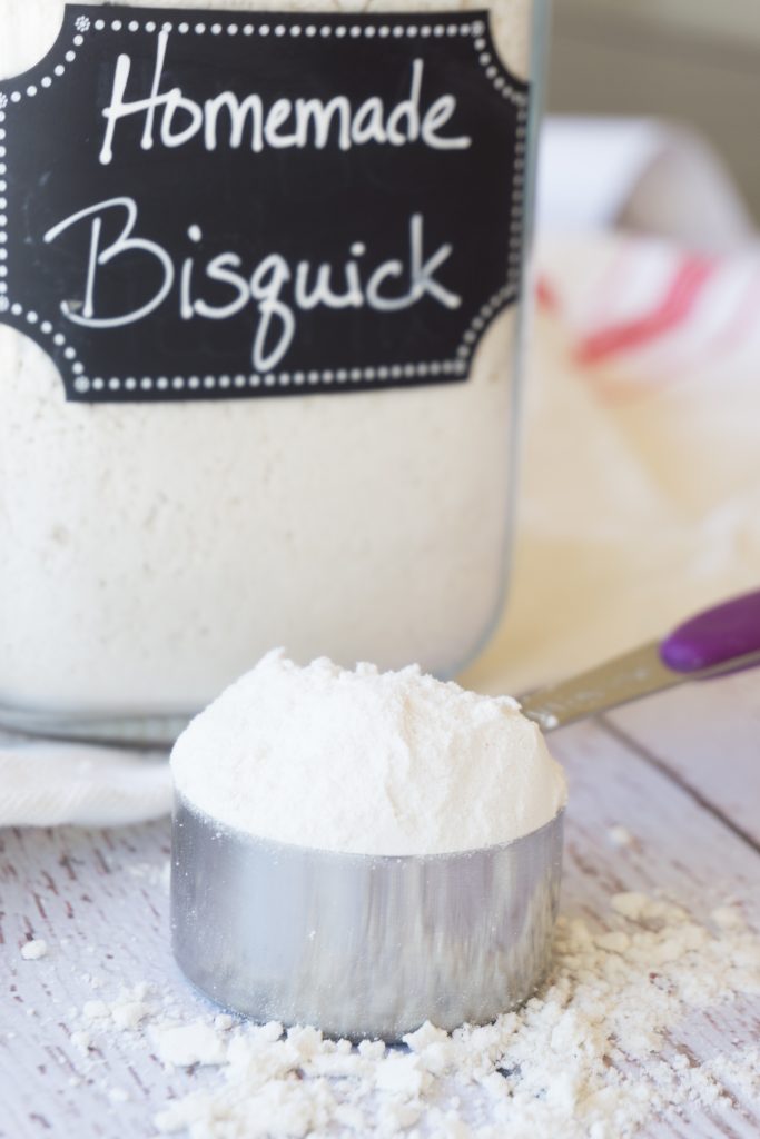 Bisquick in measuring cup in front of jar