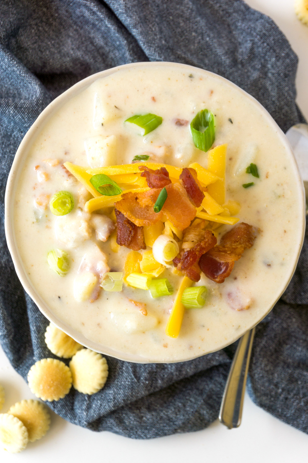 bowl of Boston clam chowder garnished with cheese and bacon