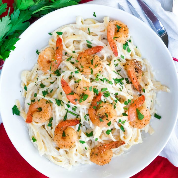 spicy shrimp alfredo in a white bowl