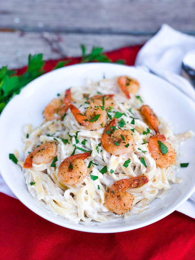 spicy shrimp alfredo in a white bowl