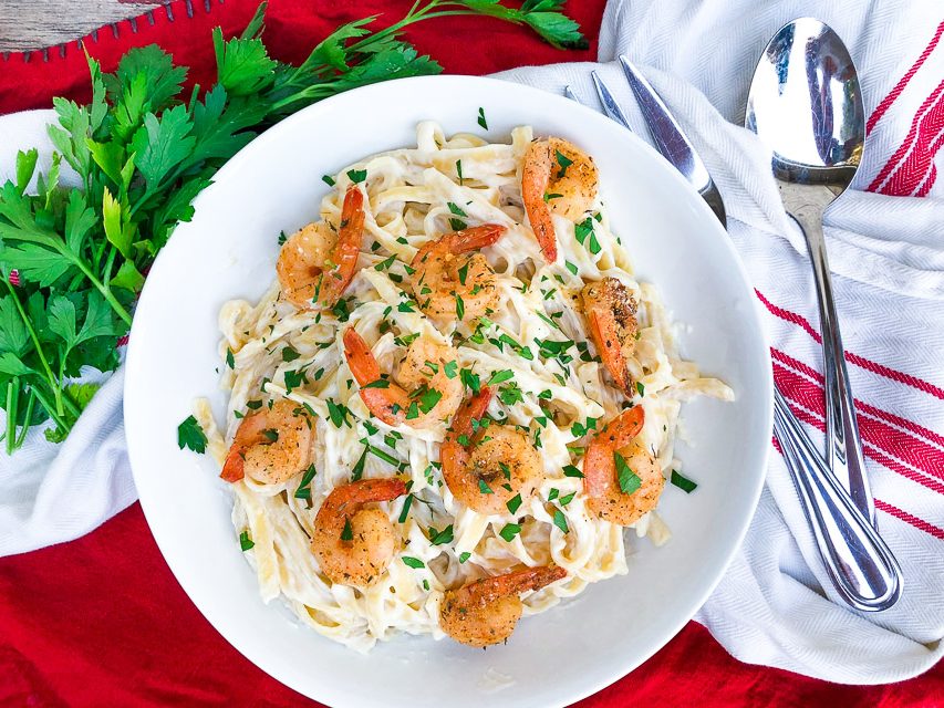 spicy shrimp alfredo in a white bowl