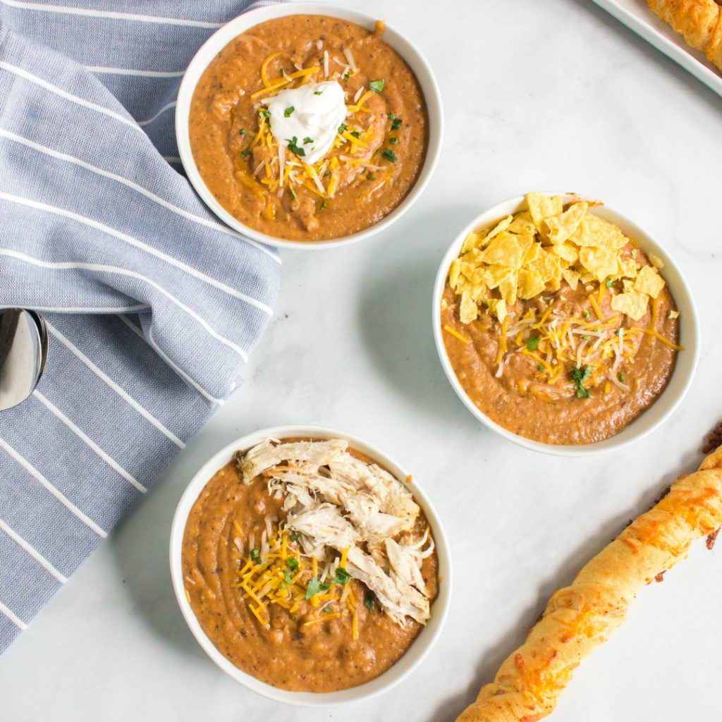 overhead photo: 3 white bowls of southwest chicken tortilla soup