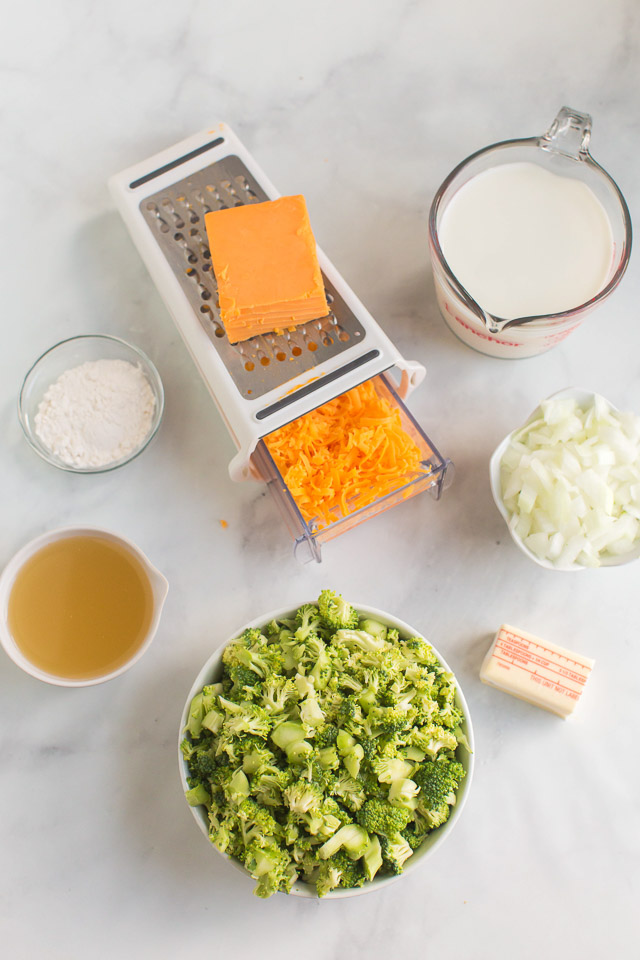 overhead photo: prepped ingredients on white counter to make cheddar broccoli soup recipe