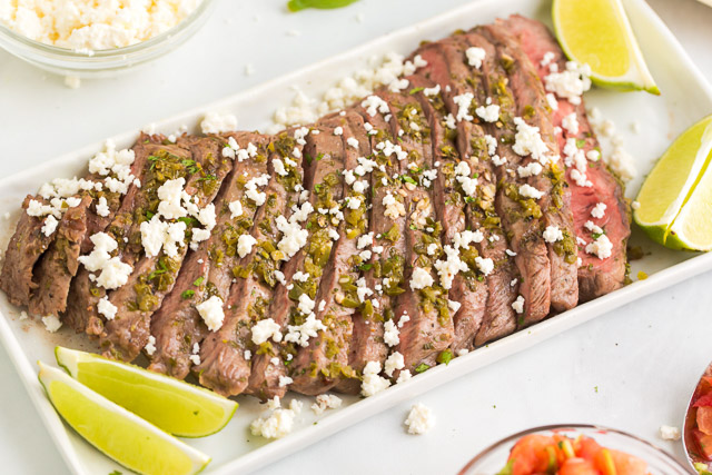 slices of Mexican steak sprinkled with Cojita cheese and lime wedges