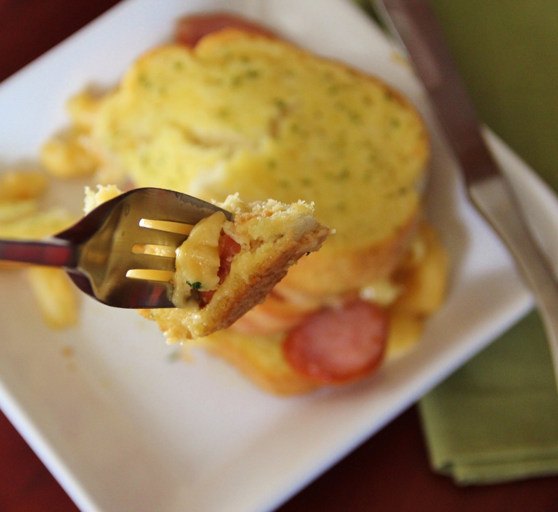 bite of grilled macaroni and cheese sandwiches on fork