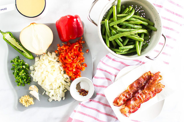 overhead photo: fresh green beans and other ingredients on counter to make sauteed green beans side dish