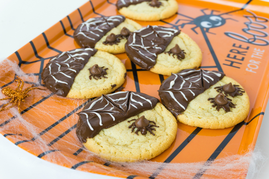 spider cookies on orange platter