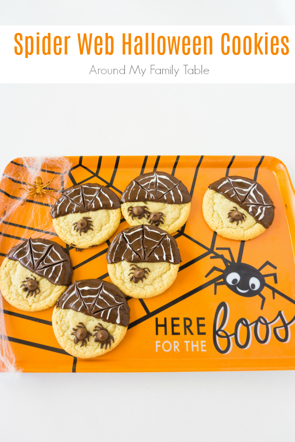 These Spider Web Halloween Cookies are easy and festive. Perfect for kids to create, a Halloween party, or for school treats. #halloween #halloweenrecipes #cookies #halloweencookies #spiders via @slingmama
