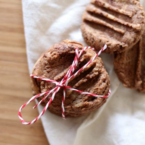 Flourless Chocolate Peanut Butter Cookies tied with twine into a stack