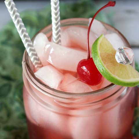 glass of boozy cherry limeade