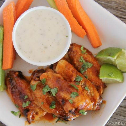 Honey Sriracha Chicken Wings on a platter with ranch dressing