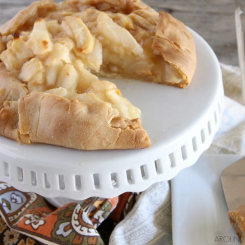 rustic pear tart on a cake stand