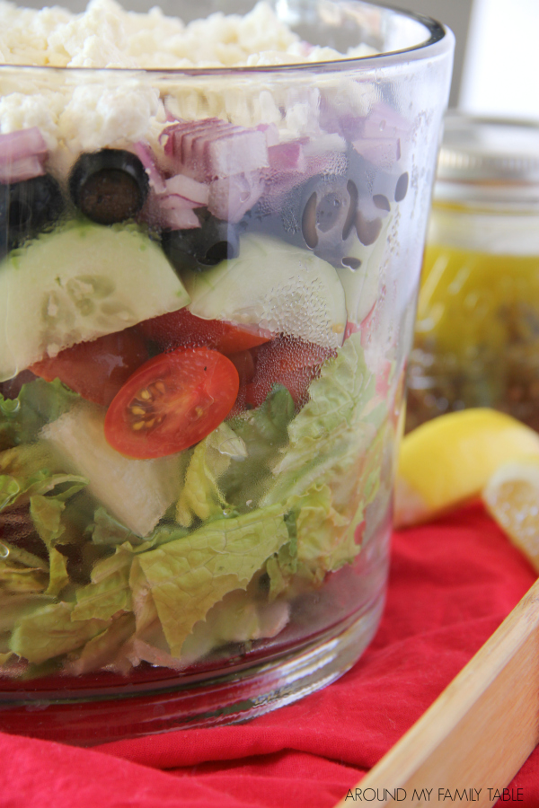 Serve this Layered Greek Salad for supper this week and it will be devoured in no time! Everyone loves how beautiful it is!