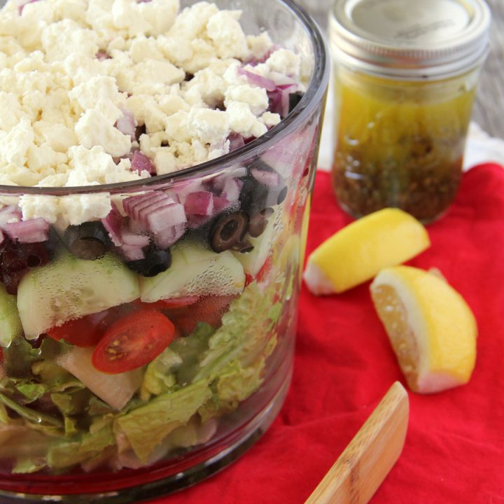 Serve this Layered Greek Salad for supper this week and it will be devoured in no time! Everyone loves how beautiful it is!