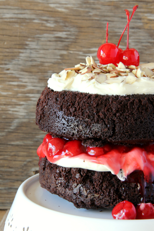 You will never make a plain box of brownies again once you make this stunning BLACK FOREST BROWNIE CAKE with the flavors and look of a traditional Black Forest Cake, but with a decadent chocolate fudge brownie.