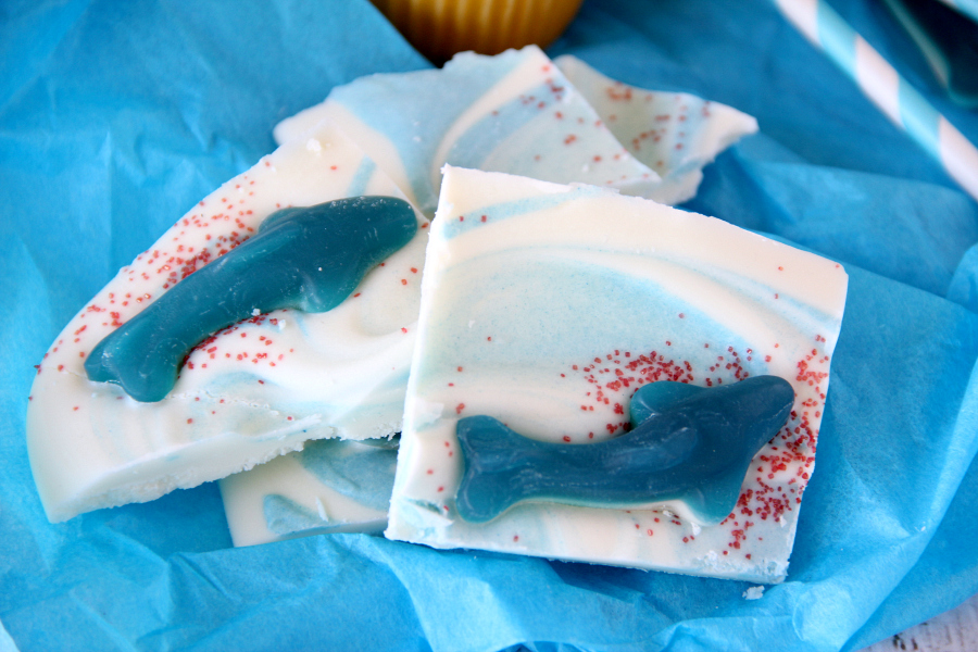 Satisfy your sweet tooth with this easy to make Shark Bark Candy. Be sure you make enough so you can handle the feeding frenzy during SHARK WEEK!