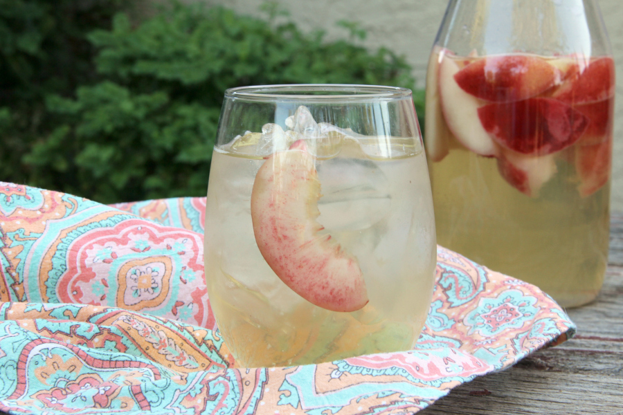 Sip on this refreshing PEACH SANGRIA all summer long. Only 4 simple ingredients and tons of peachy goodness!