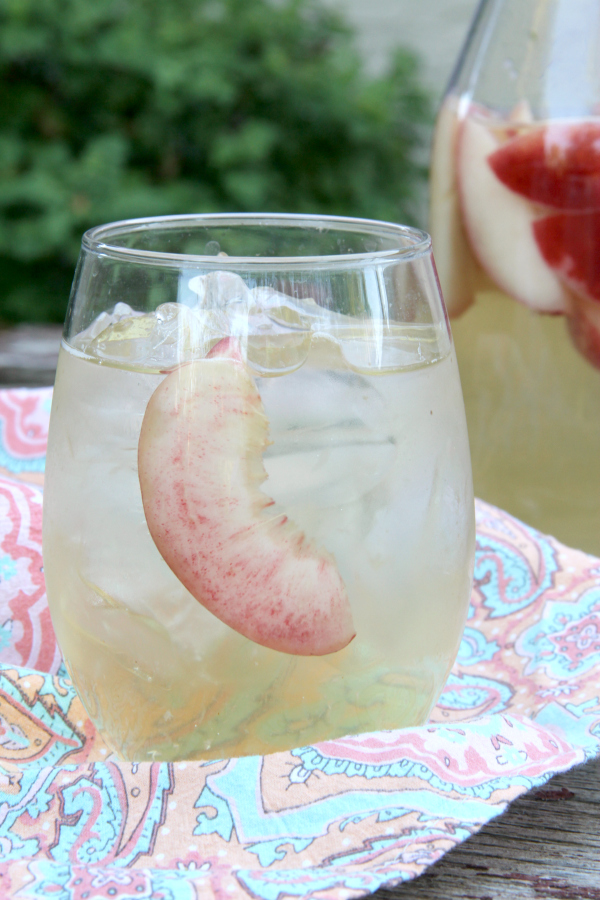 Sip on this refreshing PEACH SANGRIA all summer long. Only 4 simple ingredients and tons of peachy goodness!