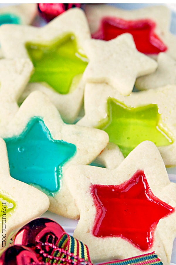 Stained glass cookies are a delicious, beautiful, and easy to make holiday cookie. Soft, buttery cookie dough, rolled out and cut into holiday shapes, then filled with melted candies so they look like stained glass.