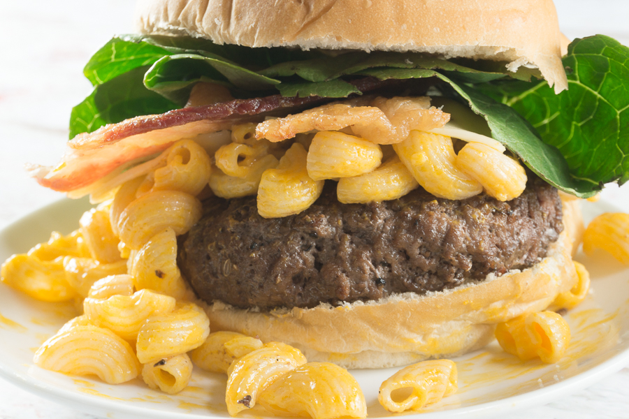 I've kicked up our plain ol' cheeseburger to this colossal Mac & Cheese Burger. A perfectly grilled burger topped with my favorite macaroni and cheese and of course loads of bacon...it's absolute perfection!