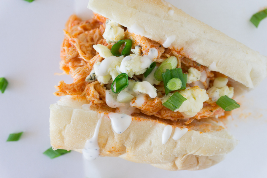 These spicy Slow Cooker Buffalo Chicken Sandwiches are sure to be the hit of any party.  They are perfect for homegating parties, holiday parties, or just for an easy supper.