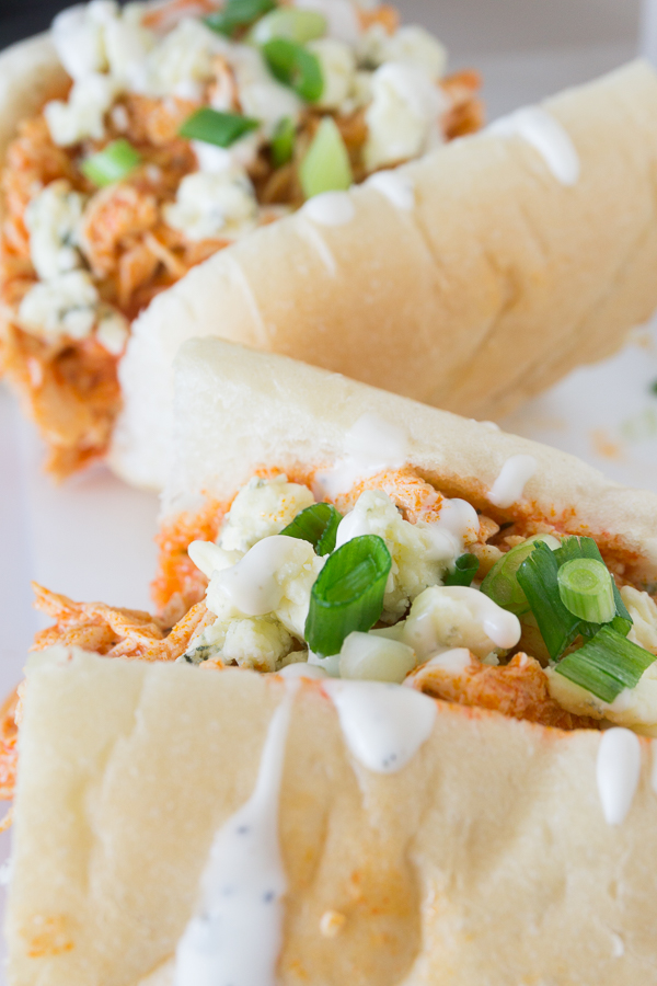 These spicy Slow Cooker Buffalo Chicken Sandwiches are sure to be the hit of any party.  They are perfect for homegating parties, holiday parties, or just for an easy supper.