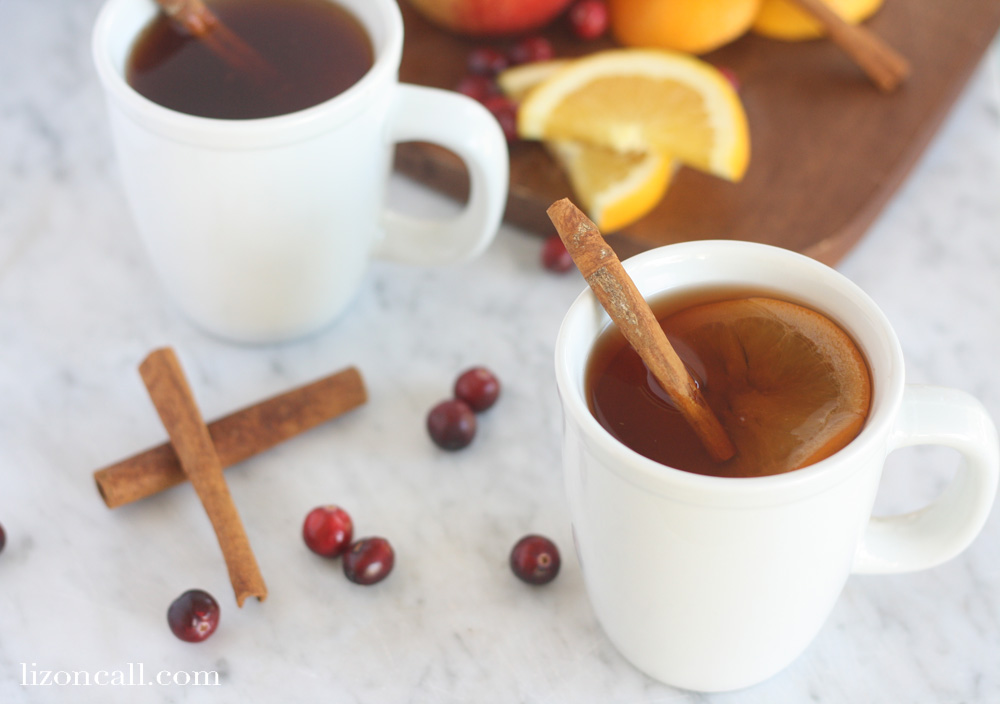 two white mugs filled with slow cooker party punch