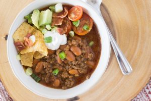 In less than an hour, this Instant Pot Chili Recipe will be hot and ready and taste like it's been simmering all day.  Add all the fixin's for a fun Chili Bar that will be the talk of your homegating party! #chili #chilibar #instantpot