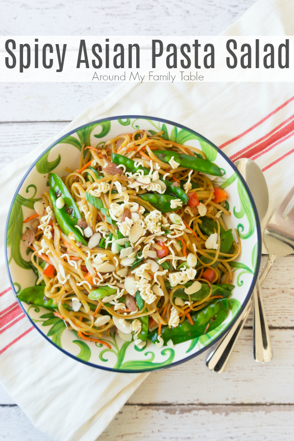 Change up your traditional summer pasta salad for this Spicy Asian Pasta Salad, it will be the hit of all your summer parties! This pasta salad is full of fresh vegetables and topped with some crushed ramen noodles and slivered almonds. #pastasalad