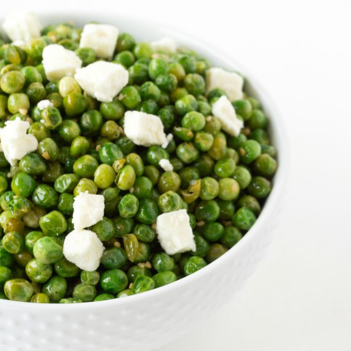 If you haven't tried pan roasted peas you are missing out.  My Roasted Peas with Garlic & Feta is a quick, easy, and delicious side dish.  The sweet flavor of the peas goes nicely with the tangy feta and roasting them just takes the peas to a whole other level.