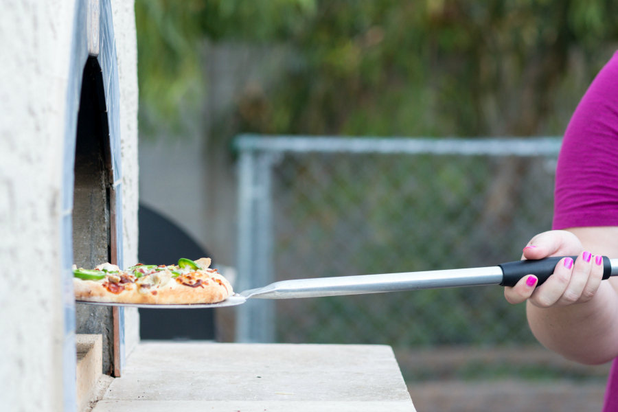 cooking pizza in an authentic wood fired pizza oven from forno bravo