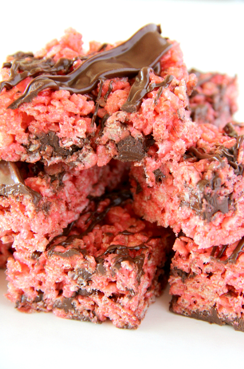 Grab a couple of these Chocolate Covered Strawberry Rice Krispies Treats because I might have created a monster when I added strawberry jello to my favorite rice krispies treats recipe and then drizzled chocolate all over the top.  