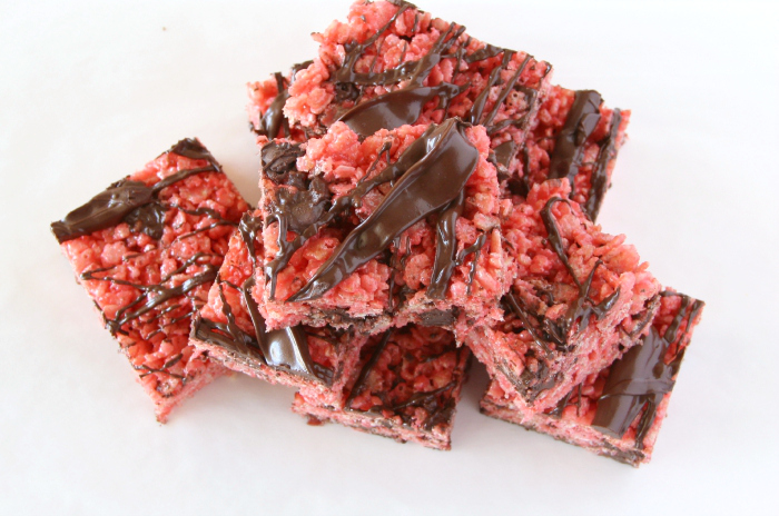 Grab a couple of these Chocolate Covered Strawberry Rice Krispies Treats because I might have created a monster when I added strawberry jello to my favorite rice krispies treats recipe and then drizzled chocolate all over the top.  