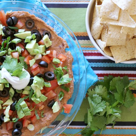 Fresh vegetables, taco seasoning, beans and little bit of sour cream layered in a pretty dish are turned into a delicious and Healthy Layered Taco Dip that are perfect for any party.