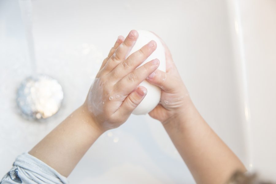 Close up pic of the hands of a little girl getting wash with soap