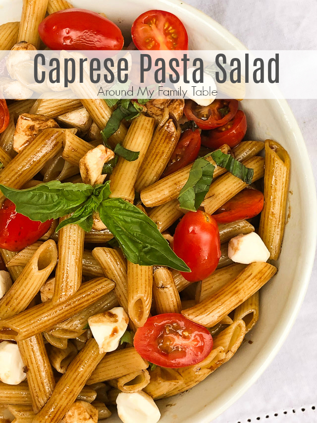 pasta in a white bowl with tomatoes, basil and cheese