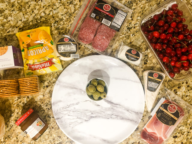 summer charcuterie board ingredients on a granite counter