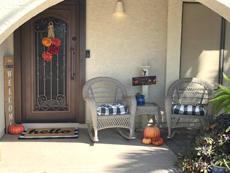 fall porch with pumpkins and buffalo check