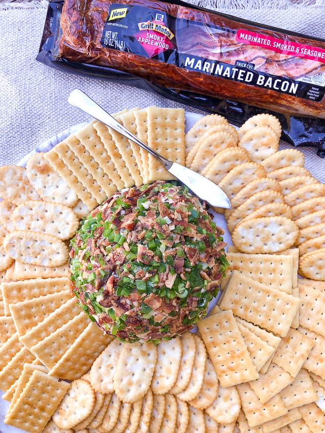 Jalapeño Bacon Cheese Ball on a white platter with crackers